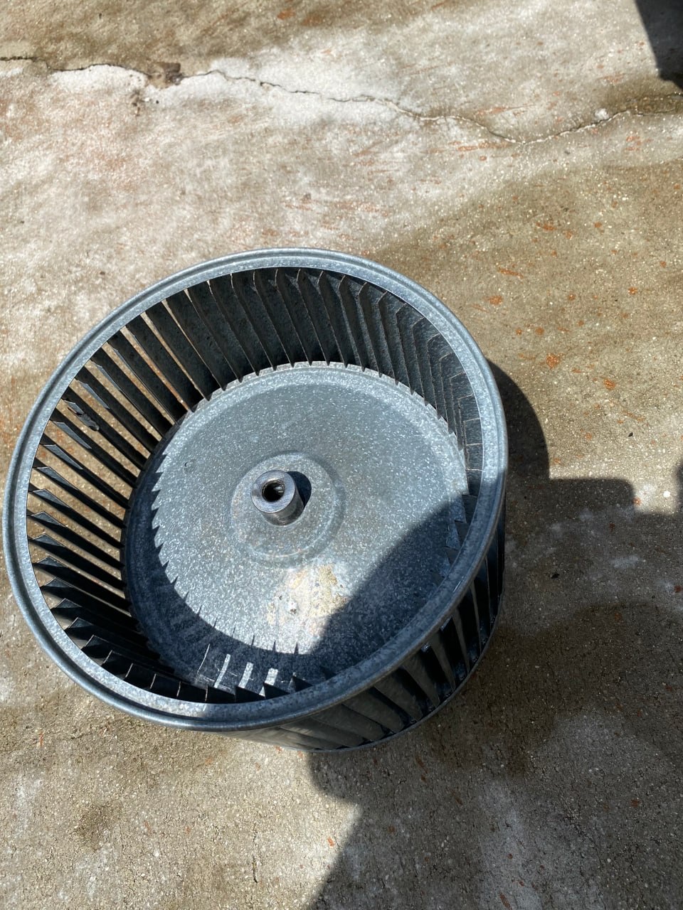 Dirty HVAC blower wheel before cleaning during air handler maintenance by Tri-County HVAC in South Florida.