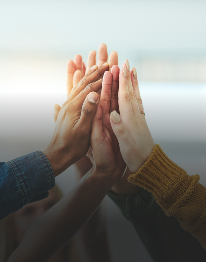 A team of volunteers giving each other a high five.
