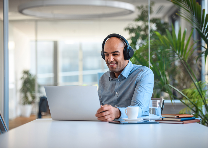 A man working on his laptop at the office.