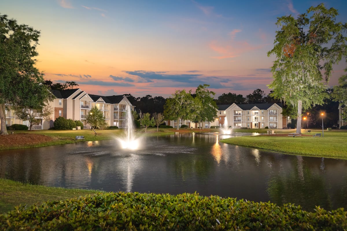 Apartment complex with a little pond in front of it