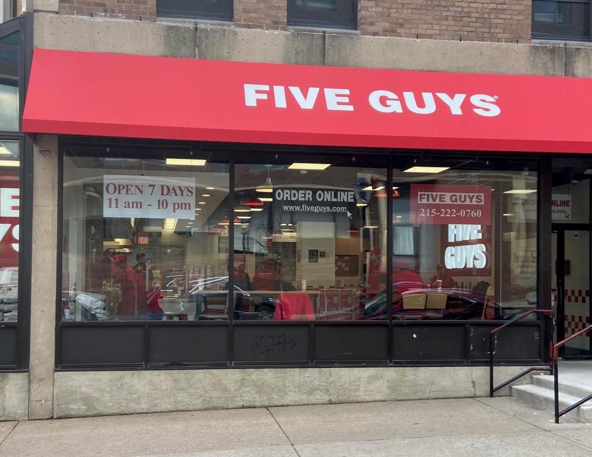 Exterior photograph of the Five Guys restaurant at 3714 Spruce Street in Philadelphia, Pennsylvania.