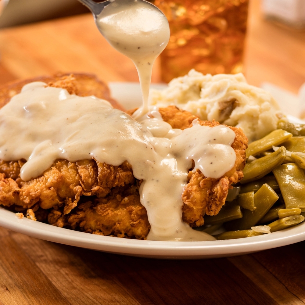 Country Fried Chicken: Hand-battered on Texas toast with gravy. Served with two sides.