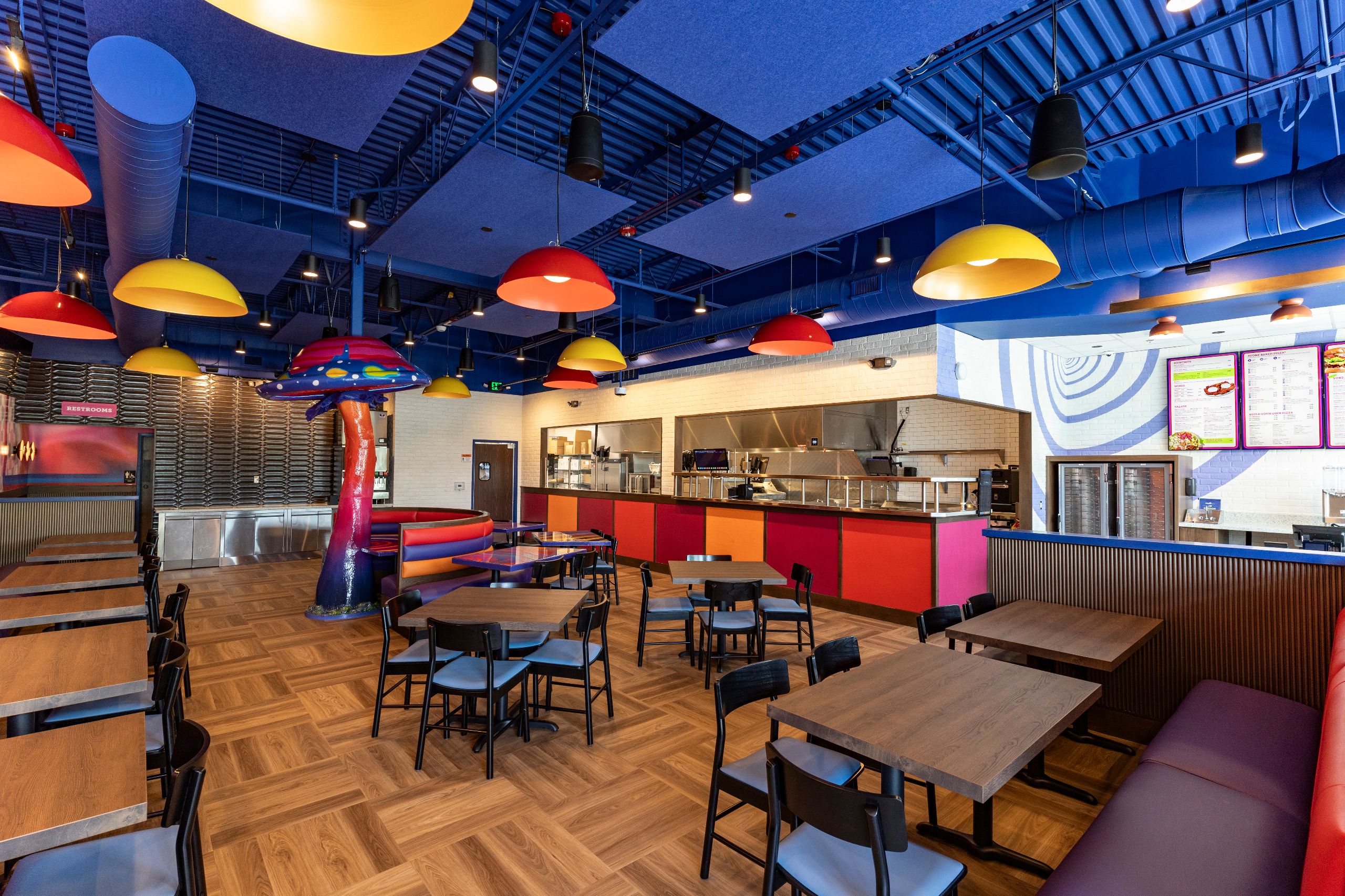 mellow mushroom newnan interior with colorful murals and mushroom sculpture