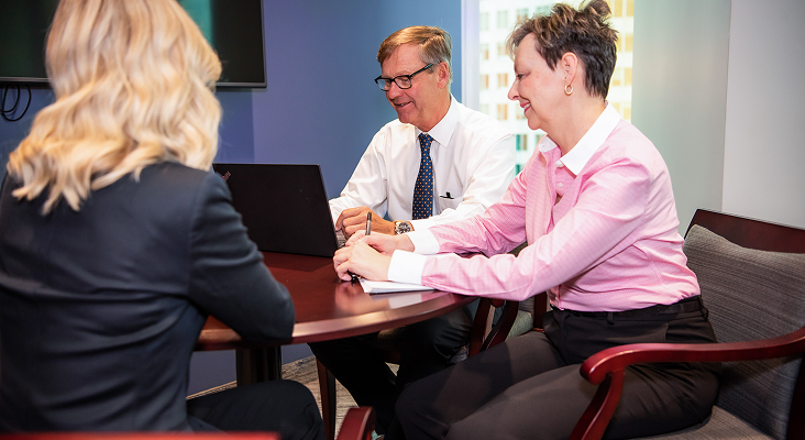 Peter Coward and team working together at a table.