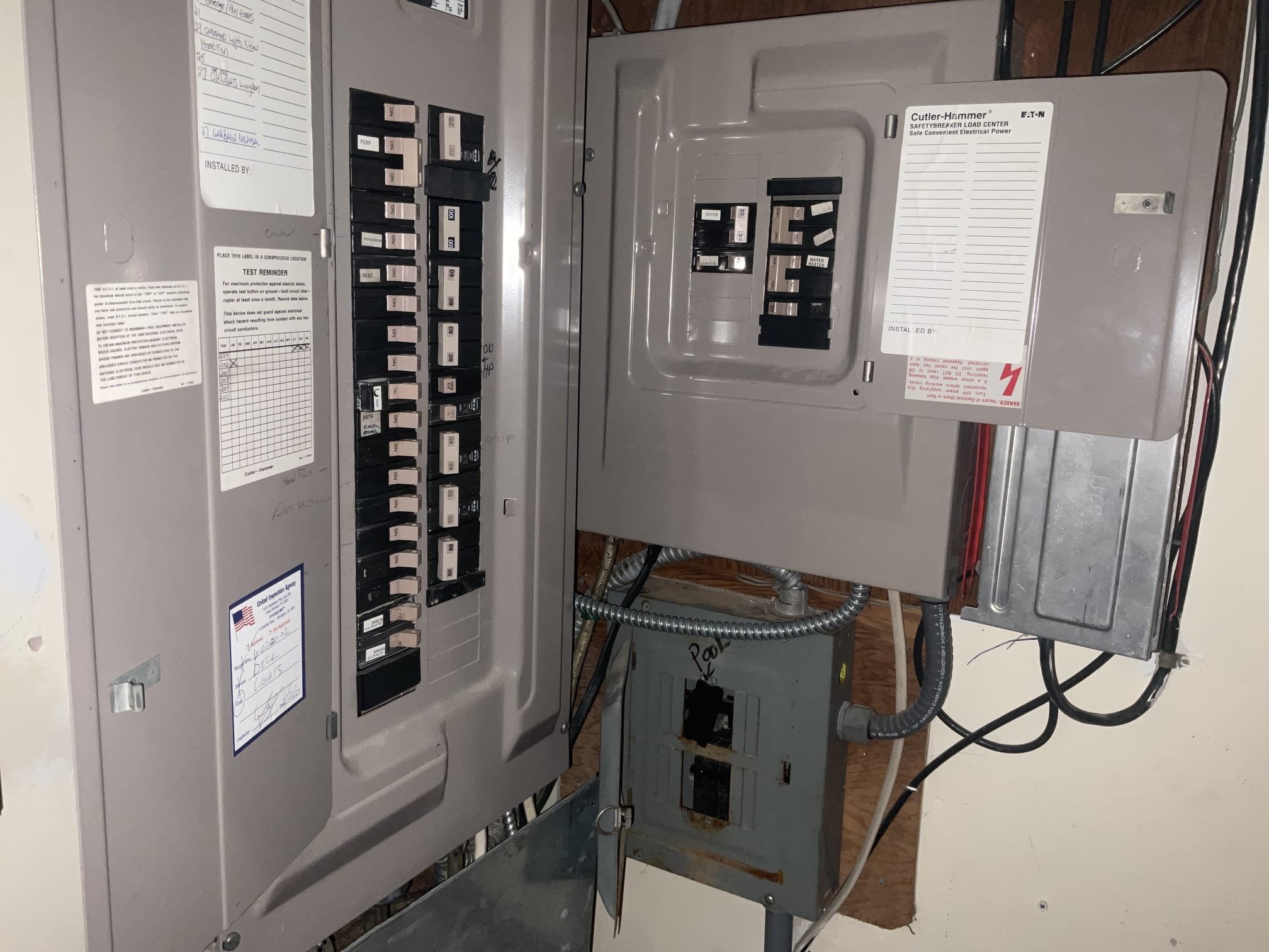 A Cutler-Hammer main breaker panel with an adjacent Eaton subpanel serviced by Thomas Edison Electric in a Norristown, PA basement. The dual-panel configuration handles the home's full electrical load, with each circuit clearly labeled for the homeowner.