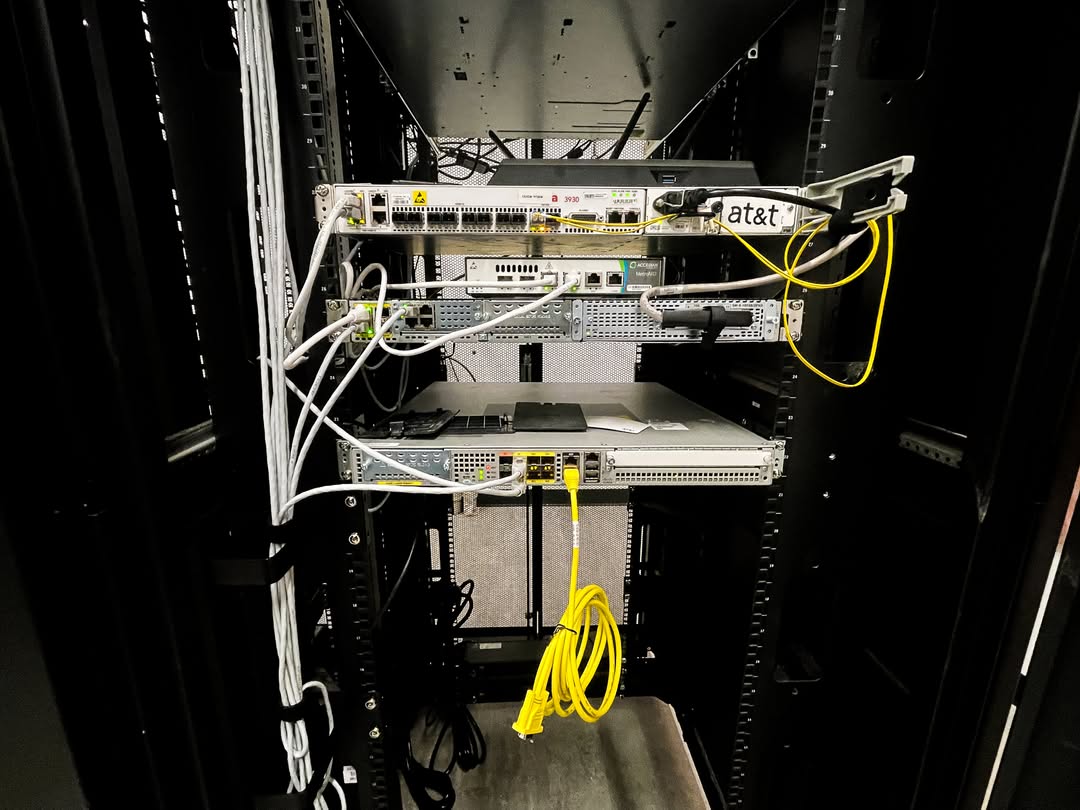 Enterprise network rack with switches, routers, and fiber connections installed for business network infrastructure