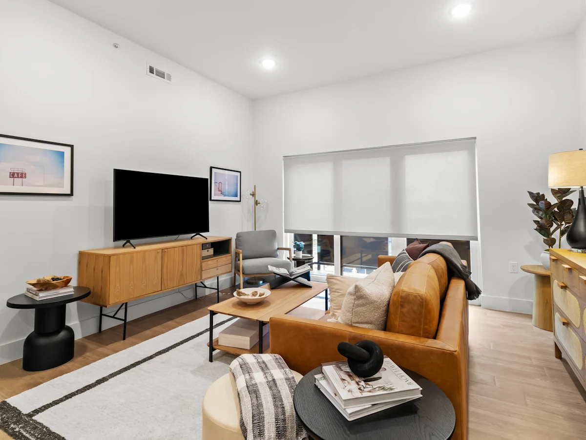 A Living Room With a Television at G at Market Apartments, Bentonville, Arkansas