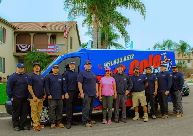 Scott Cole Plumbing team photo in front of a branded company van