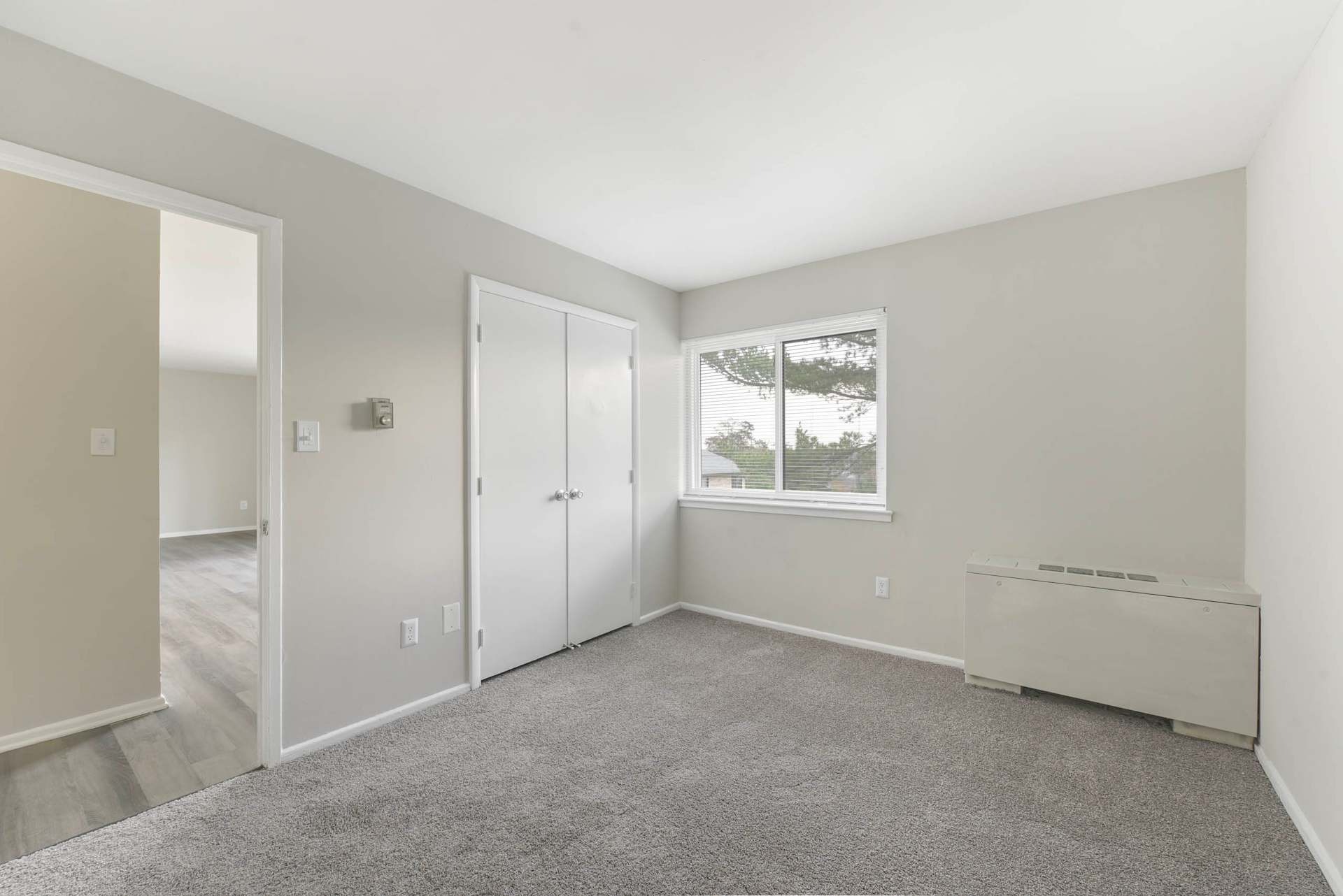 Carpeted bedroom with window