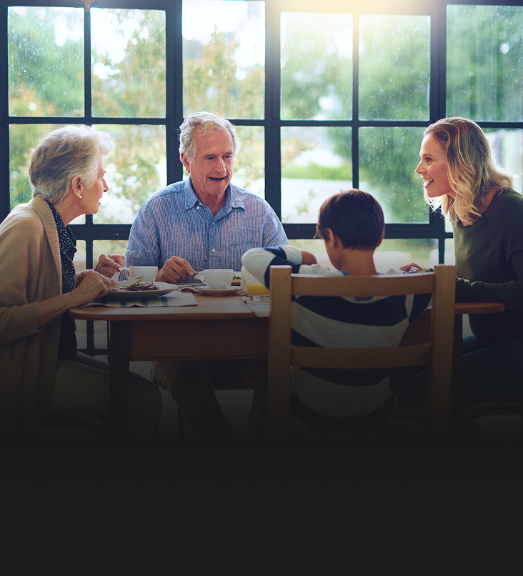 A multigenerational family enjoying a meal together at home.