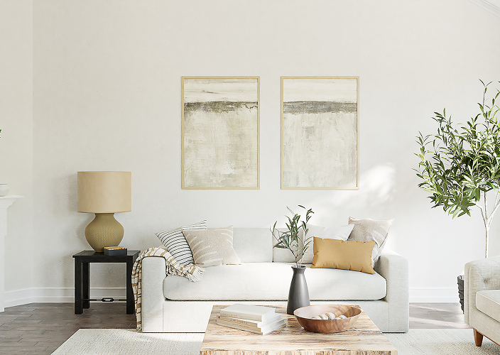 Modern living room with cream-coloured couch and warm accents.