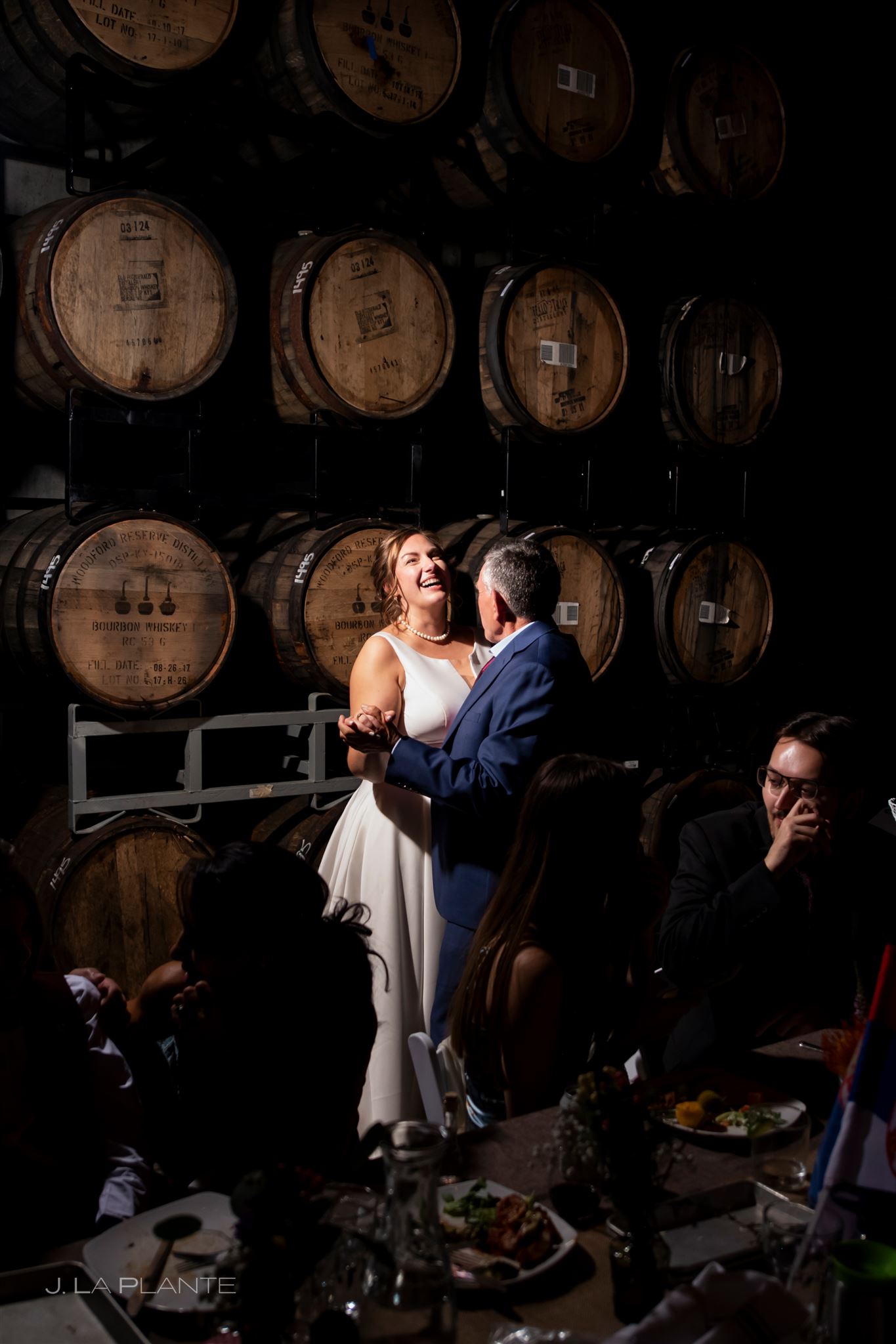 Guests gather for a wedding reception inside Acreage's barrel room, a unique private event venue overlooking the Colorado Front Range.