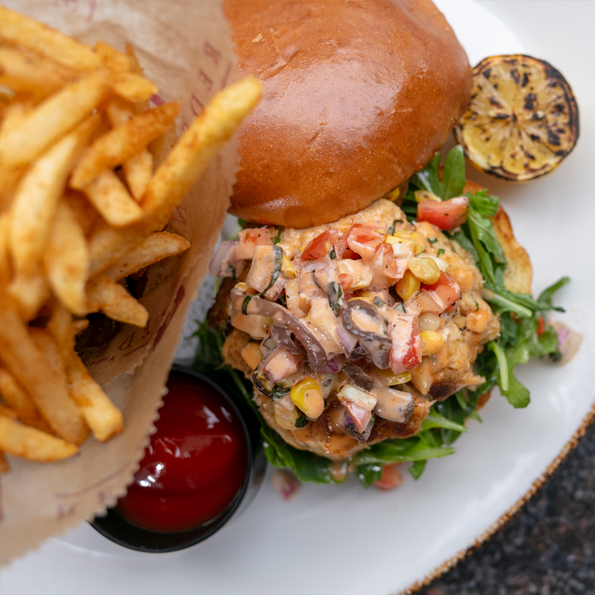 Crabcake Sandwich | jumbo lump crab, sriracha aioli, tomato corn salsa, old bay fries