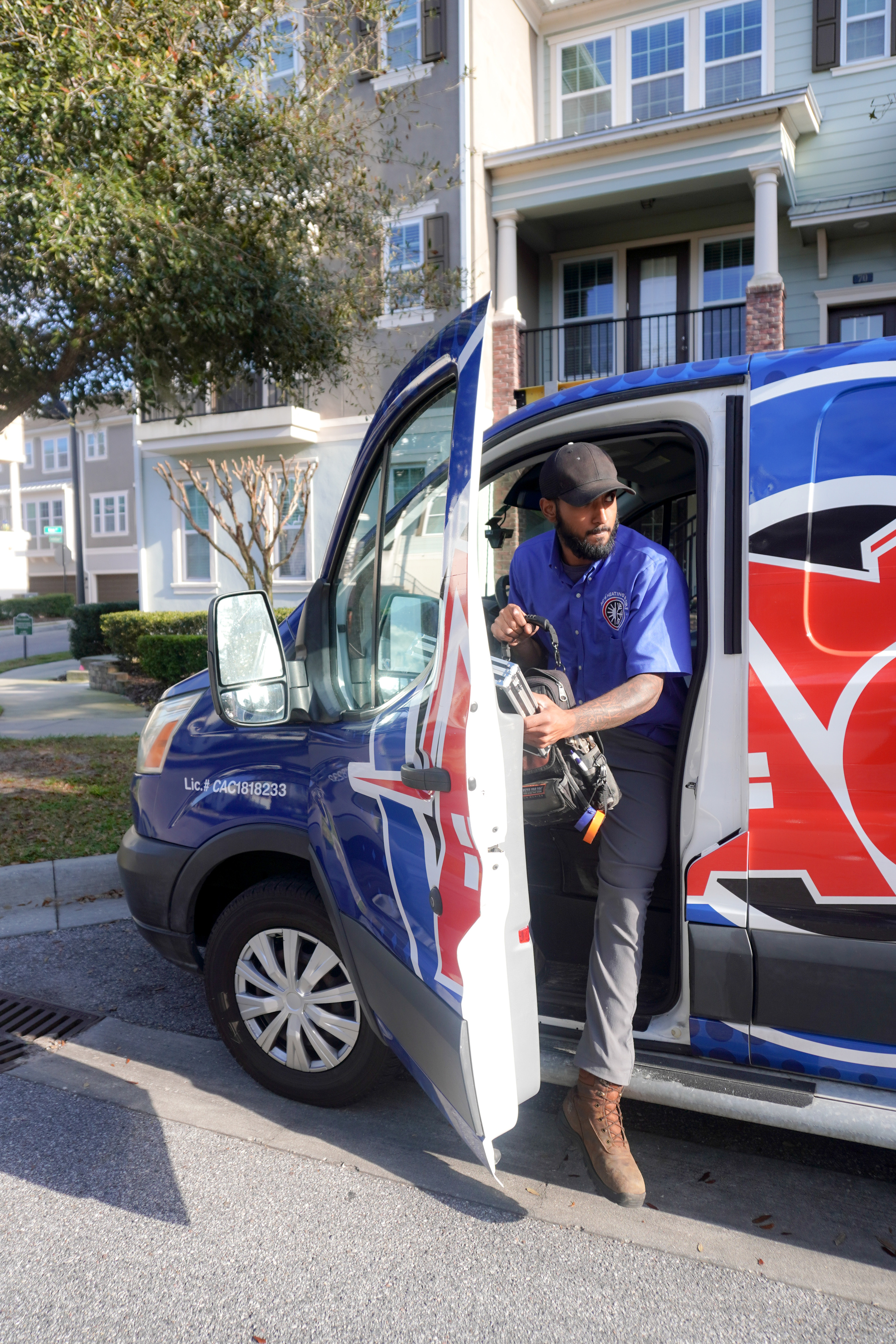 AC's Heating & Air technician leaving van, getting ready to perform a service