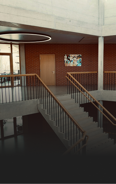 Interior shot of a nicely designed high school staircase.