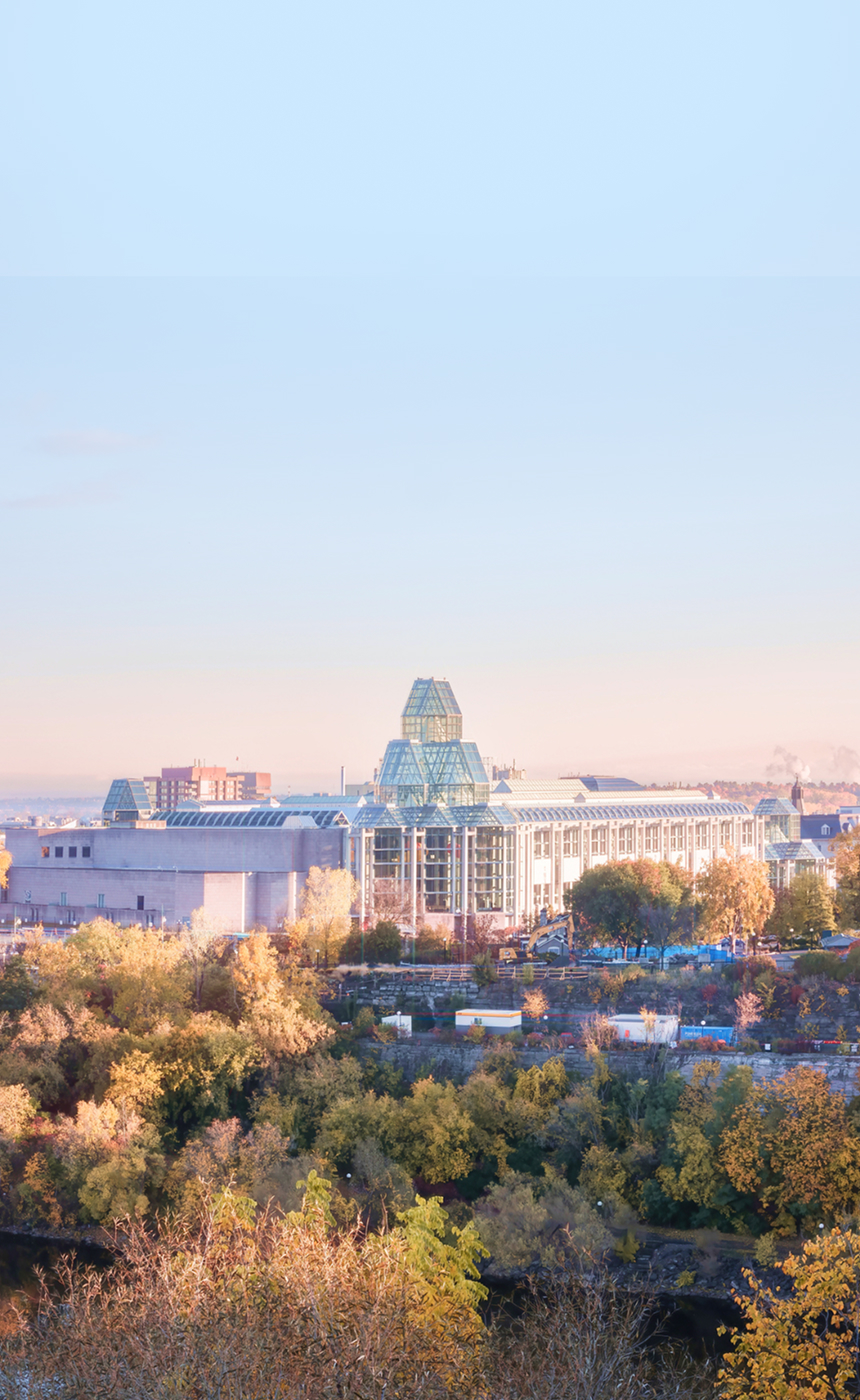 An aerial view of the Parliament Buildings in Ottawa at sunset.