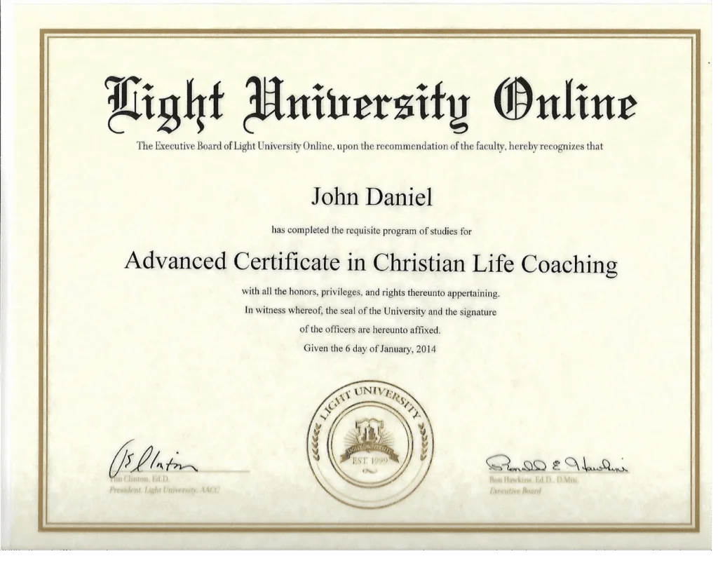 A close-up of a certificate from Light University Online, awarding John Daniel an Advanced Certificate in Christian Life Coaching on January 6, 2014. The certificate features ornate lettering and seals.