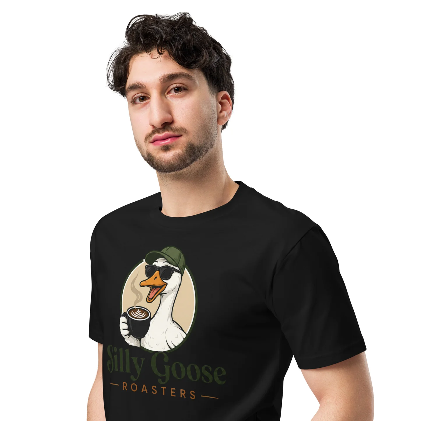 A man in a black t-shirt with a "Silly Goose Roasters" logo is shown against a white background. The logo features a cartoon goose wearing sunglasses and a baseball cap, holding a cup of coffee with latte art. The goose is depicted in a circular emblem with a tan border, and the text "Silly Goose - ROASTERS -" is below it.