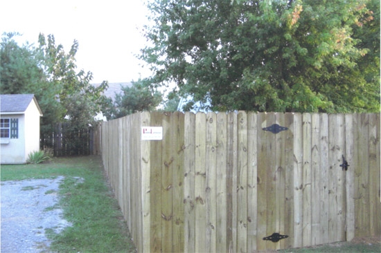 newly installed privacy fence with gate by Pro-Line Fence Co.