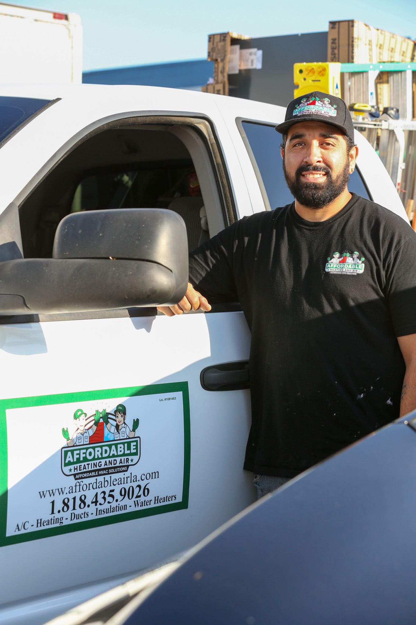 An Affordable Heating and Air technician stands beside a branded company service vehicle, ready to respond to HVAC calls across Simi Valley and Ventura County.