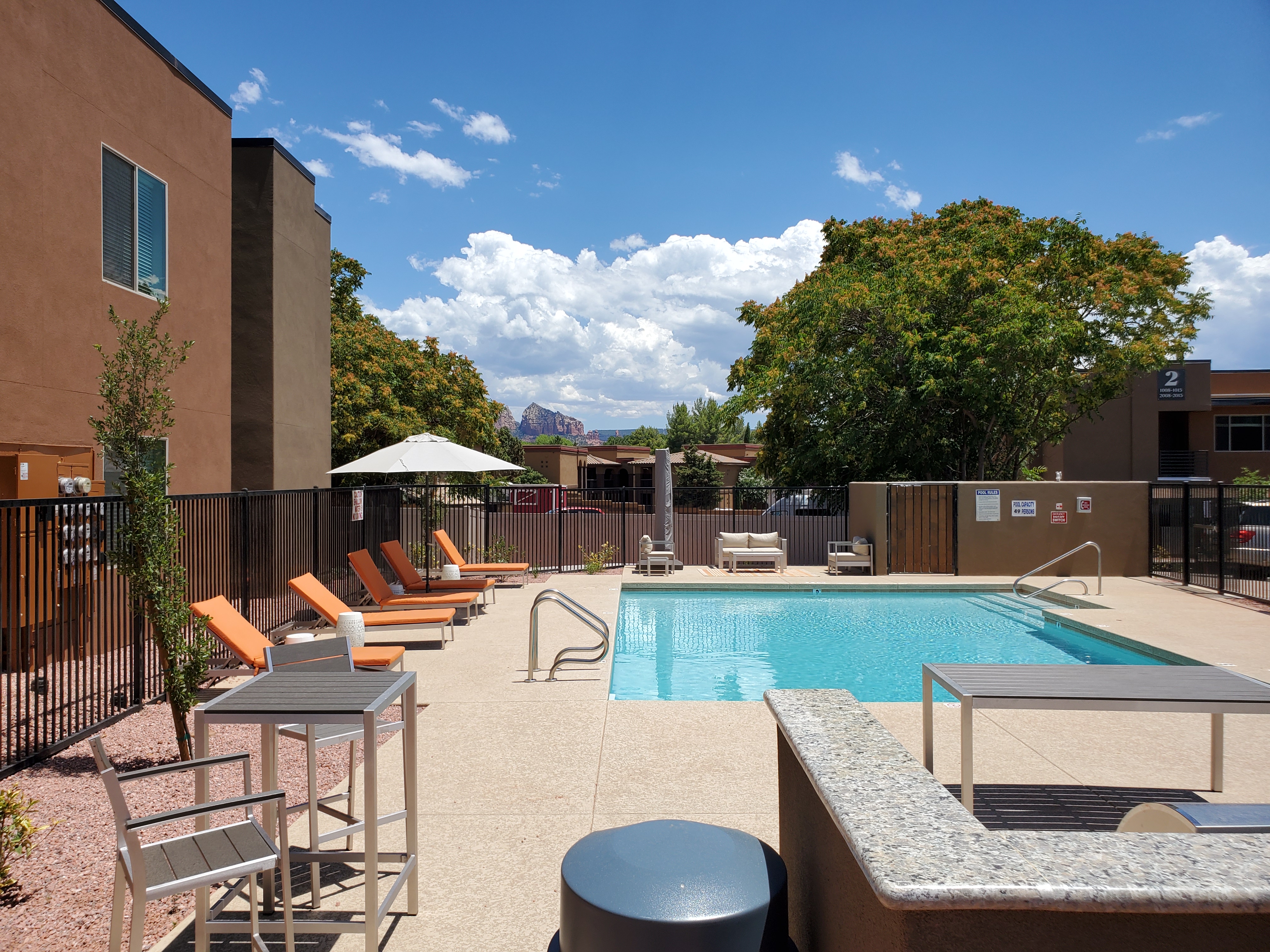 Resort style pool with lounge chairs and spa