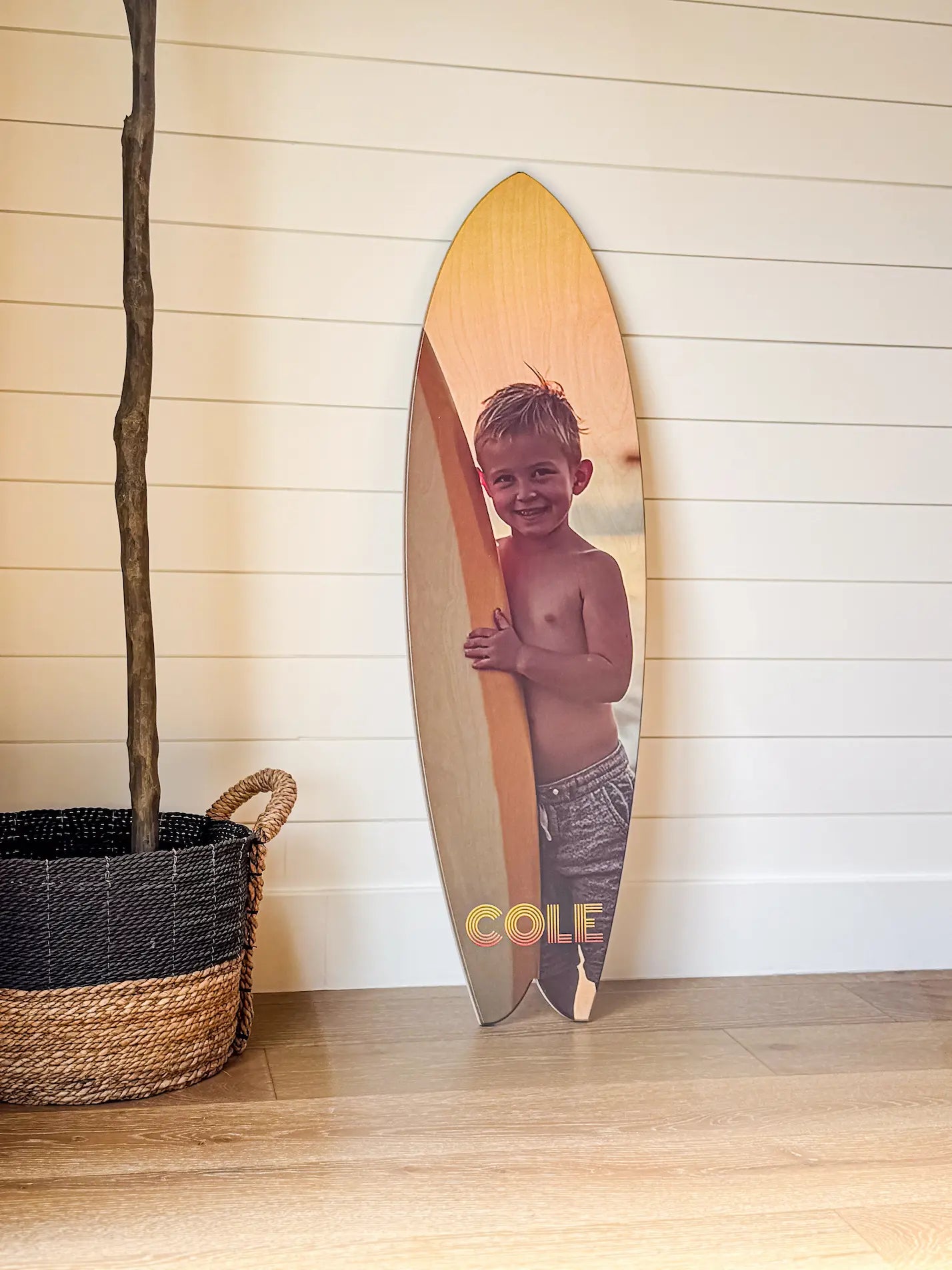 The Coastal Keepsake transforms your favorite memory into a sculptural wood print with movement, warmth, and permanence—printed directly onto high-quality Baltic birch and cut into a distinctive fishtail surfboard silhouette. Mounted with a museum-style French cleat, it floats cleanly on the wall while bringing a relaxed, coastal presence to the space. From beach photography to family moments and travel memories, each piece is designed to feel playful, personal, and built to last.
Premium Birch. Finished Like Art.
Many mass-produced "wood prints" are made on economy plywood with rough faces and minimal finishing. We use high-quality Baltic birch selected for its smoother surface and dimensional stability—so your image reproduces with greater clarity and the panel stays flatter over time. Each piece is sealed in your choice of a satin or matte finish for a refined look and lasting protection against moisture and light.
The result: sharper detail, smoother gradients, and a cleaner wood surface that looks premium up close.
True Color on Natural Grain
Your image is printed directly onto the wood using our True Color Printing Technology™, delivering rich color, soft tonal transitions, and deeper shadows—while preserving the warmth and character of the natural grain. The wood texture and surfboard shape work together to create a piece that feels both elevated and easygoing.
Made to display. Built to endure.