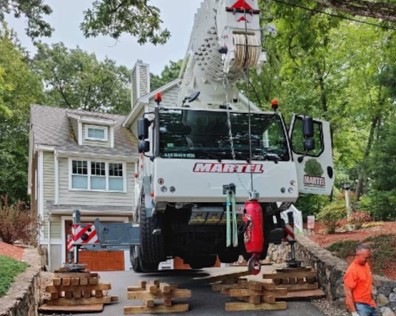 Martel Crane Service & Tree Removal removed trees from this residence in Chelmsford, MA. We used a crane on blocks to protect the customer’s driveway.