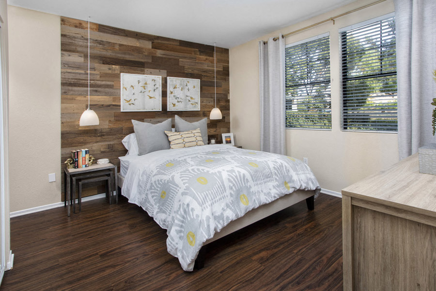 Bedroom with Hardwood Style Flooring, Large Windows, and Over Heading Lighting