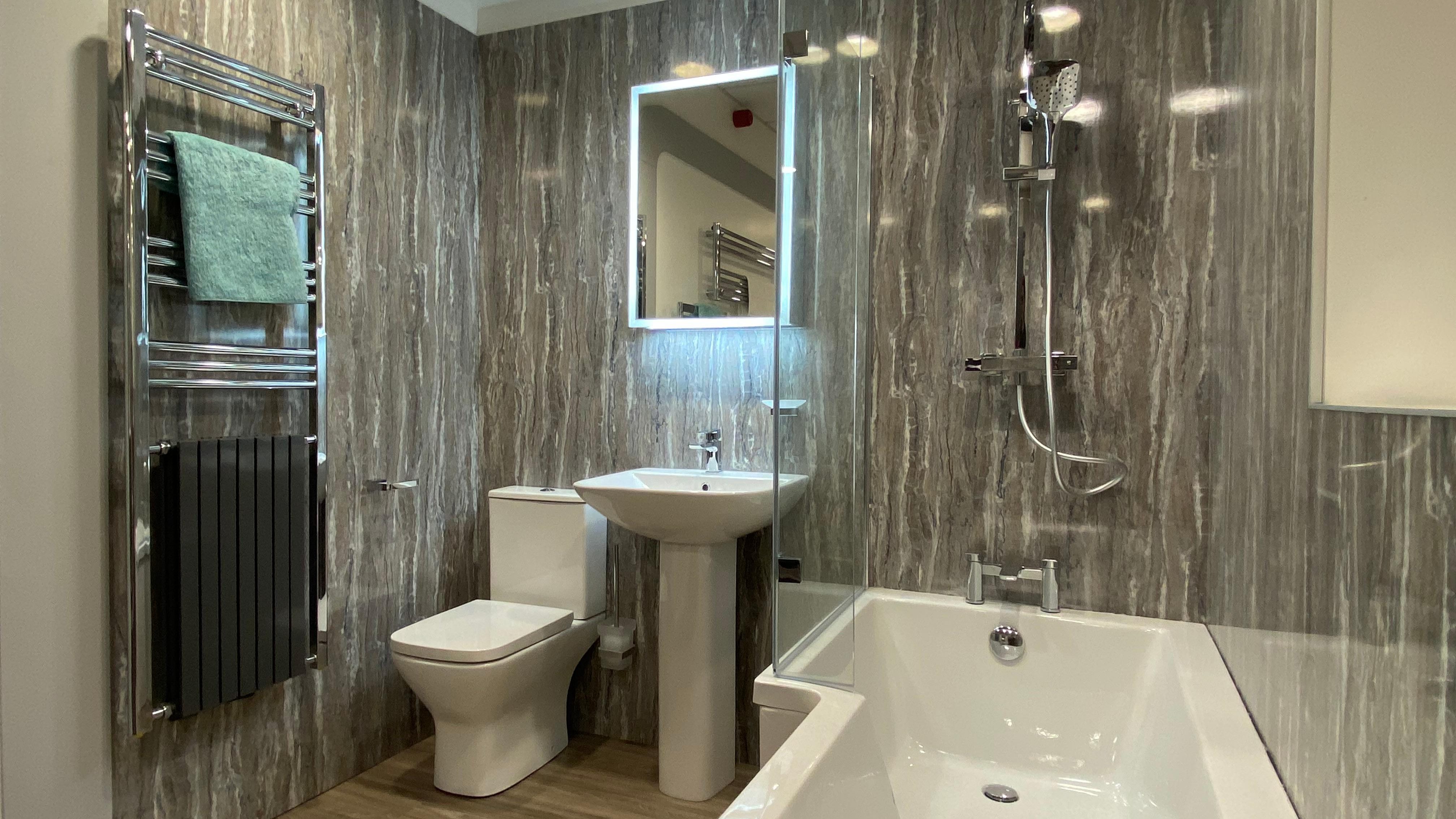 bathroom with L Shaped bath, basin, WC and towel warmer