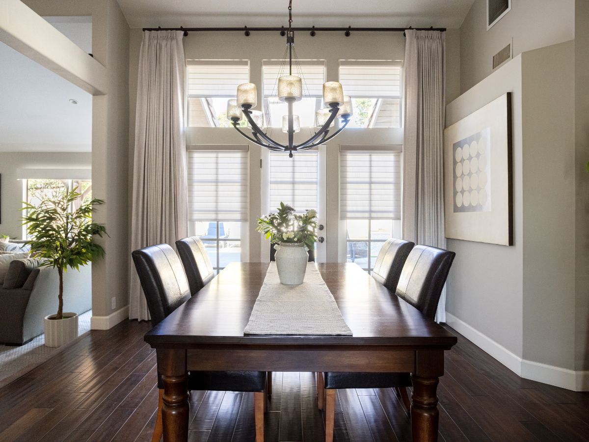 Motorized window shadings & drapery in dining room.