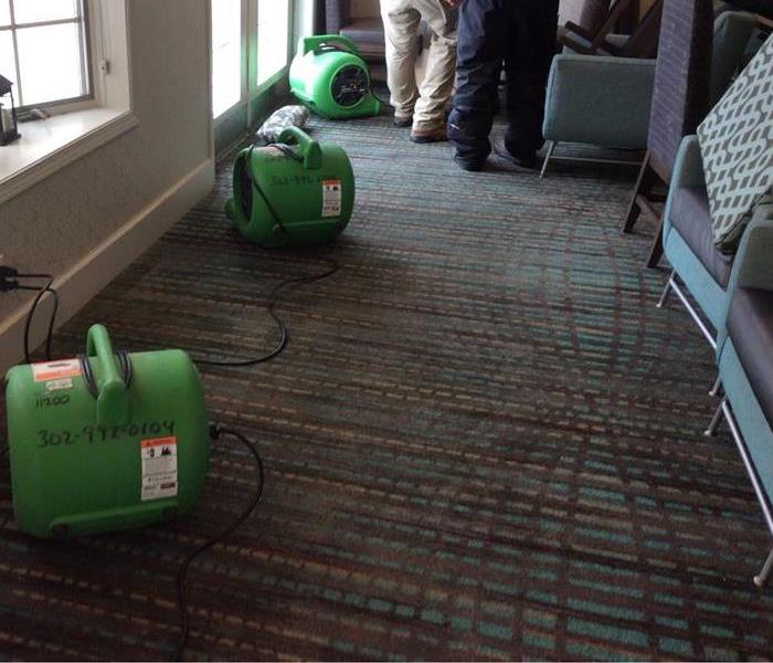 When water freezes inside a pipe, it causes the pipe to burst and often damage walls, ceilings, or flooring. This apartment building had a pipe burst due to the cold temperatures and you can see our SERVPRO fans drying out their front lobby.