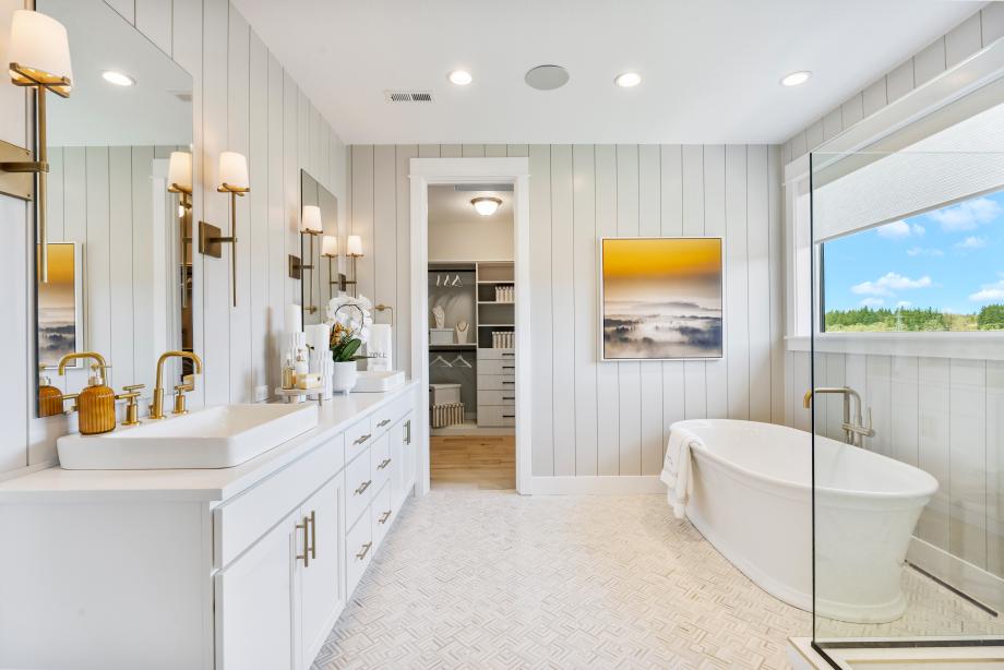 Luxe 5-piece primary bathroom features a free-standing tub and frameless glass shower enclosure