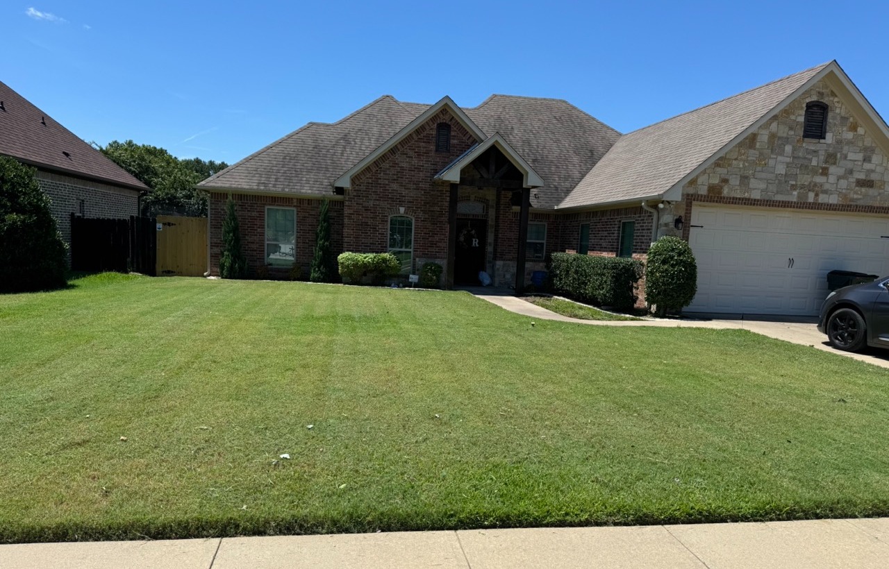 Cleaning up the hedges and grass.