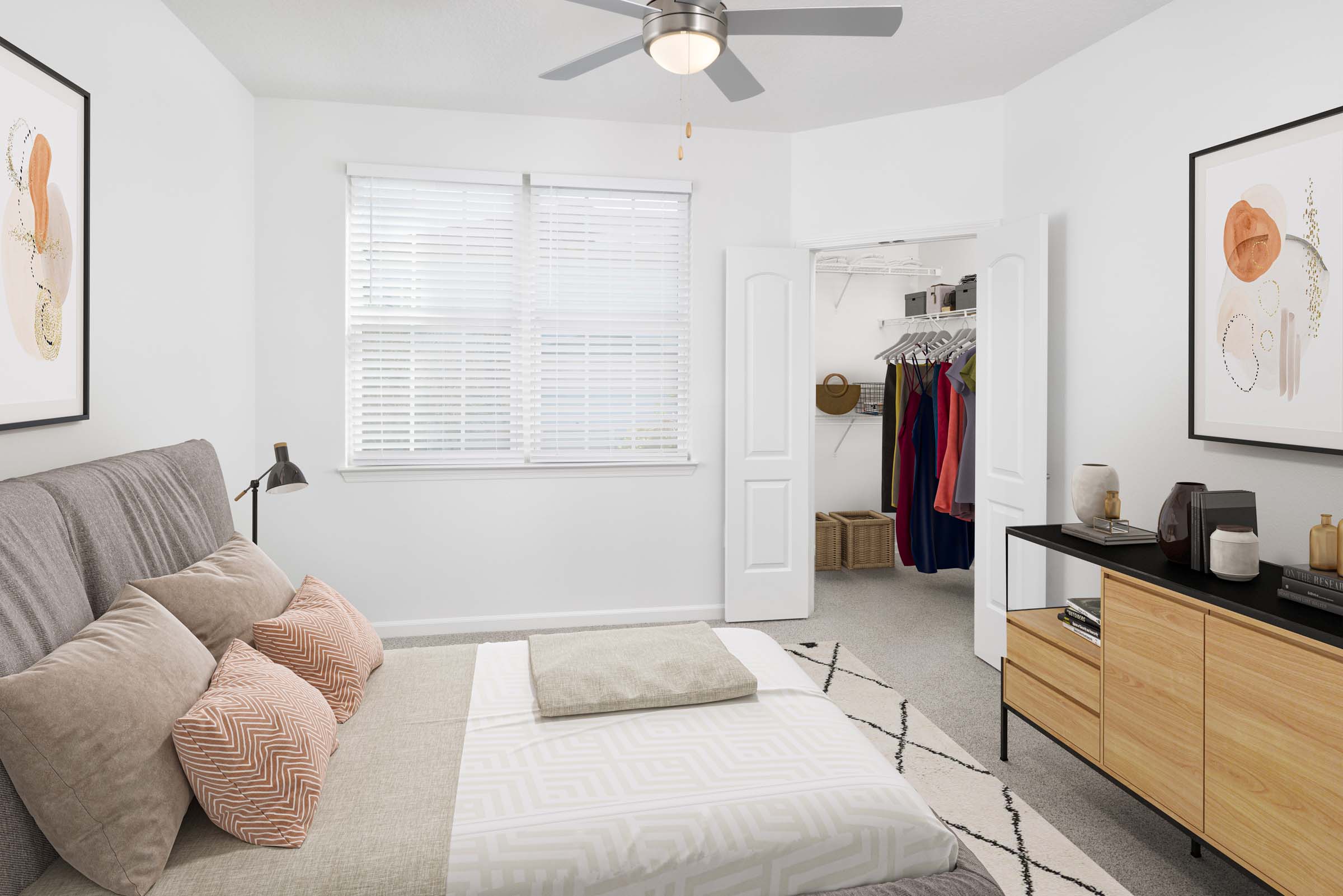 Bedroom with carpet flooring, ceiling fan, and walk-in closet at Camden Montague apartments in Tampa, FL