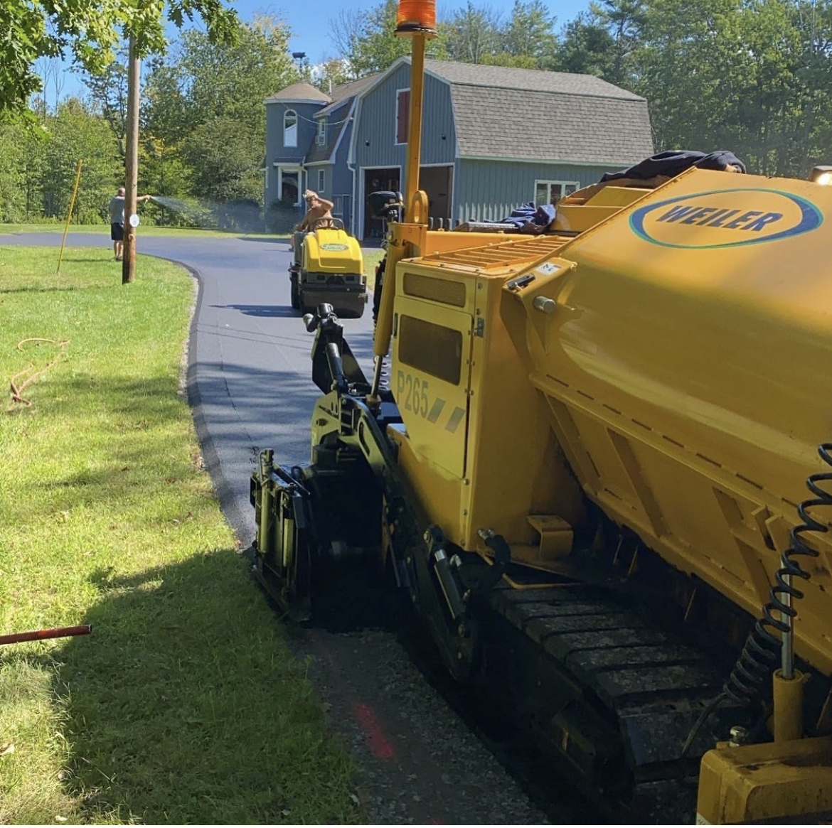 Roadway asphalt paving in progress using professional paver equipment for high-quality, long-lasting results.