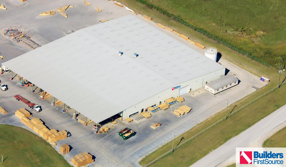 Building materials supplier Builders FirstSource's forklift is moving wood roof trusses.