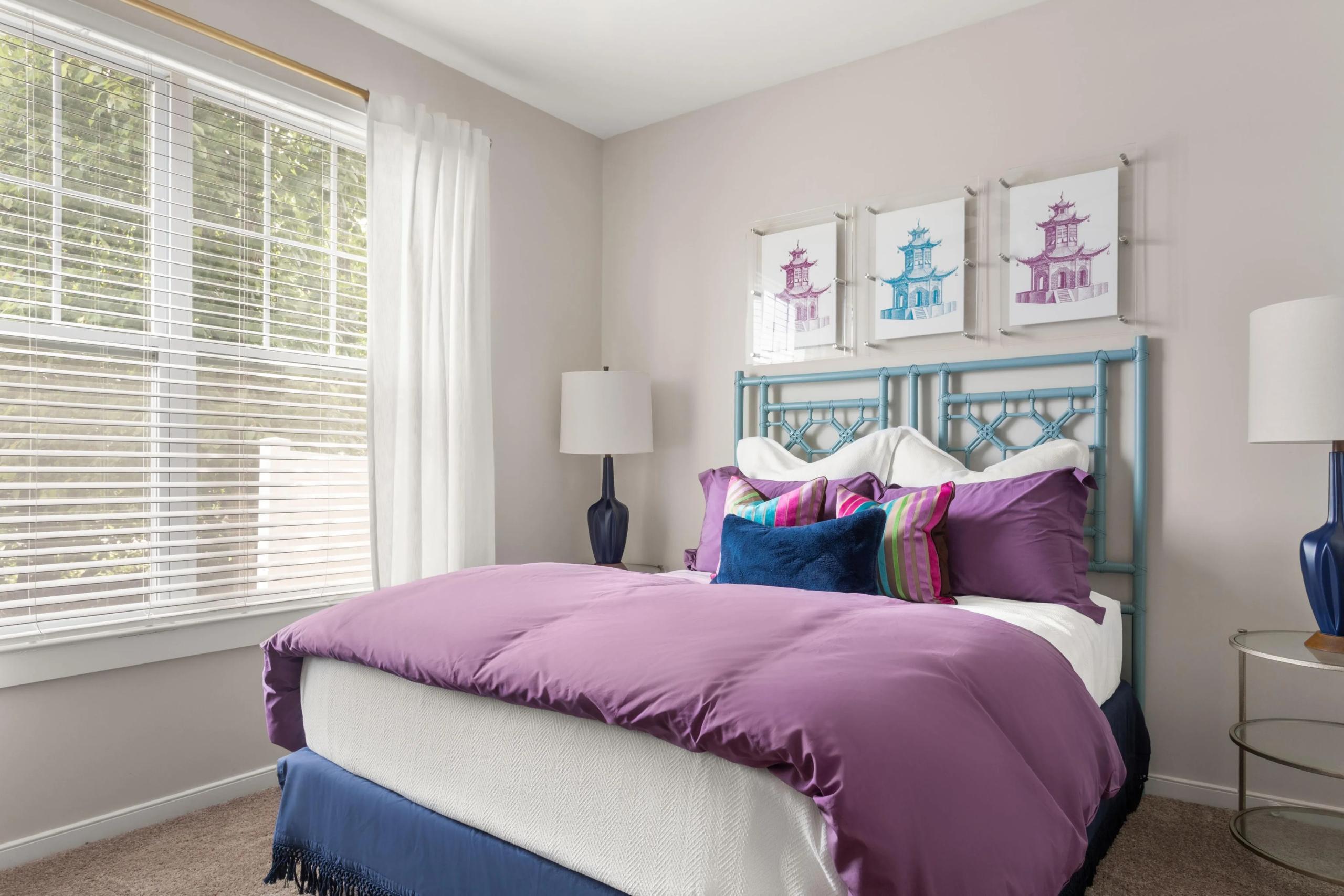Bedroom with colorful bedding and pagoda artwork