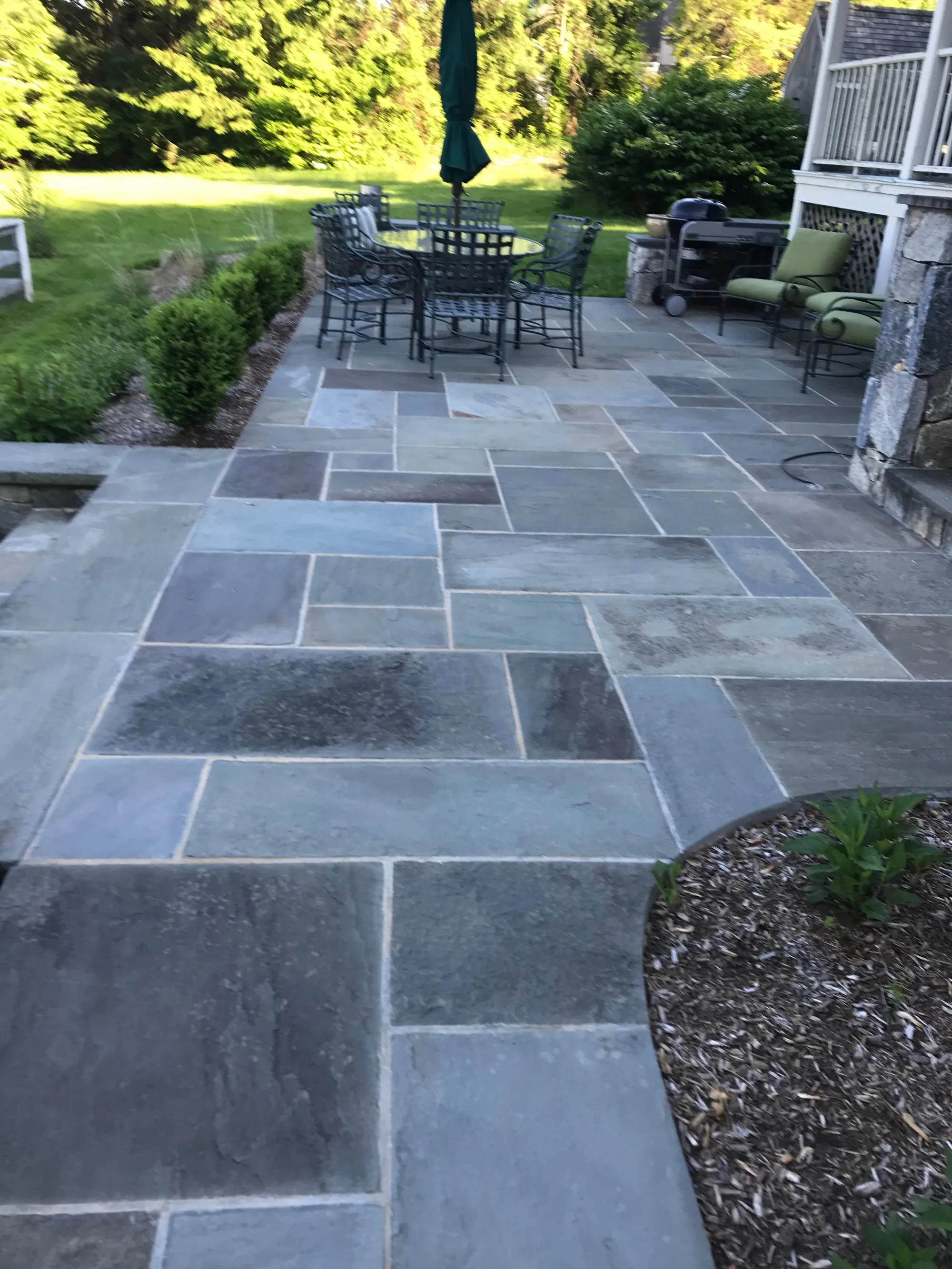 Multi-level stone patio - Patios project by General Masonry LLC.