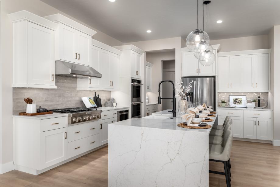 Chef inspired kitchens with gas ranges, large center islands, and abundant cabinet space