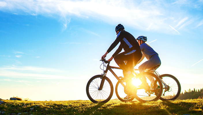 Two people riding bikes.