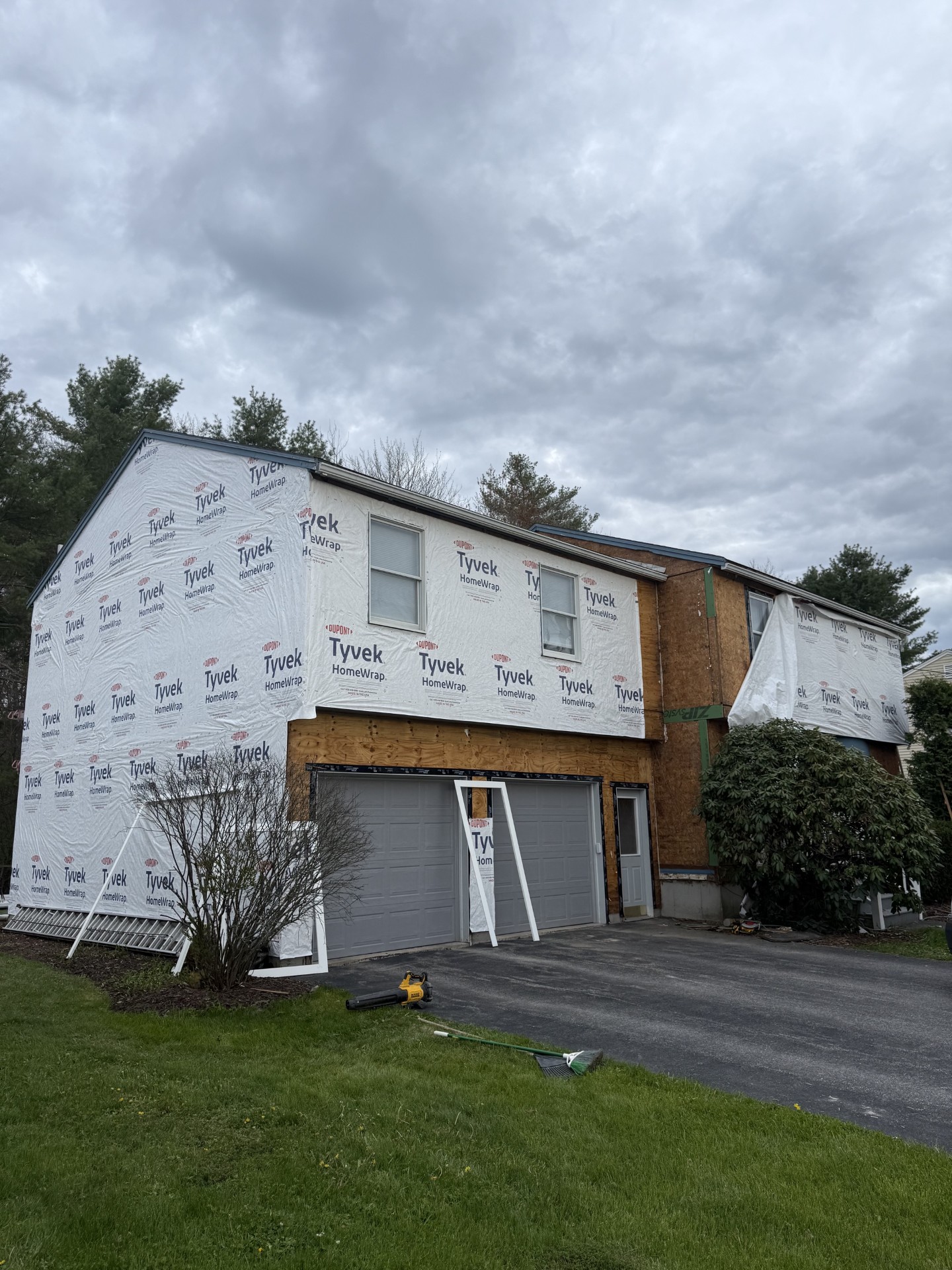 Residential home addition and exterior renovation project featuring structural framing, weatherproofing, and construction services completed by M & Son Construction.