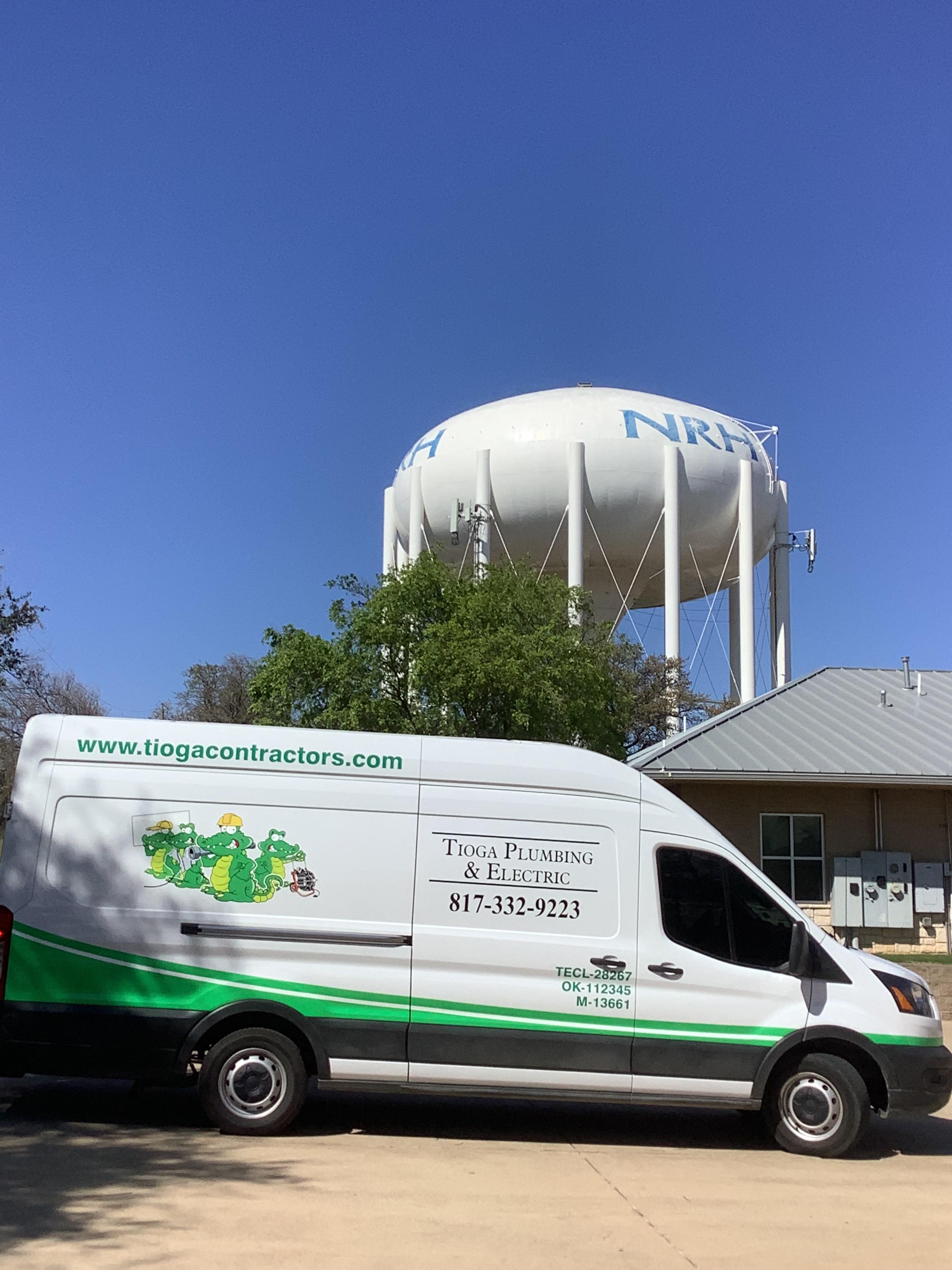 The Tioga service van in front of a NRH water tower in North Richland Hills Texas.