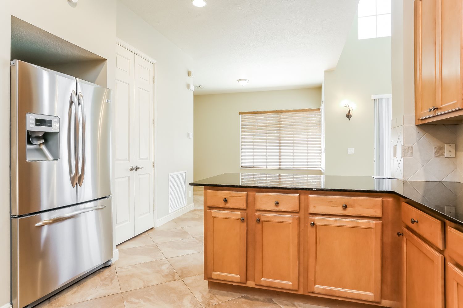 Modern kitchen with stainless steel appliances at Invitation Homes South Florida.