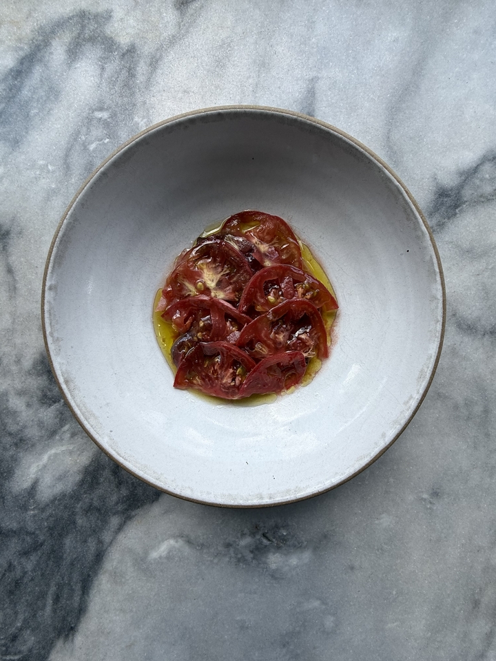 A seasonal heirloom tomato small plate, photographed overhead, at Folk in East Nashville. 