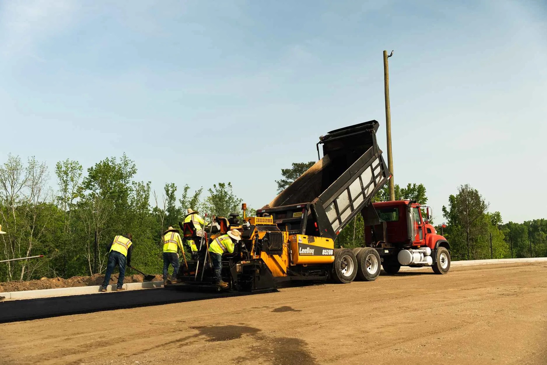 Blackjack Paving crew performing asphalt paving service for a local street.