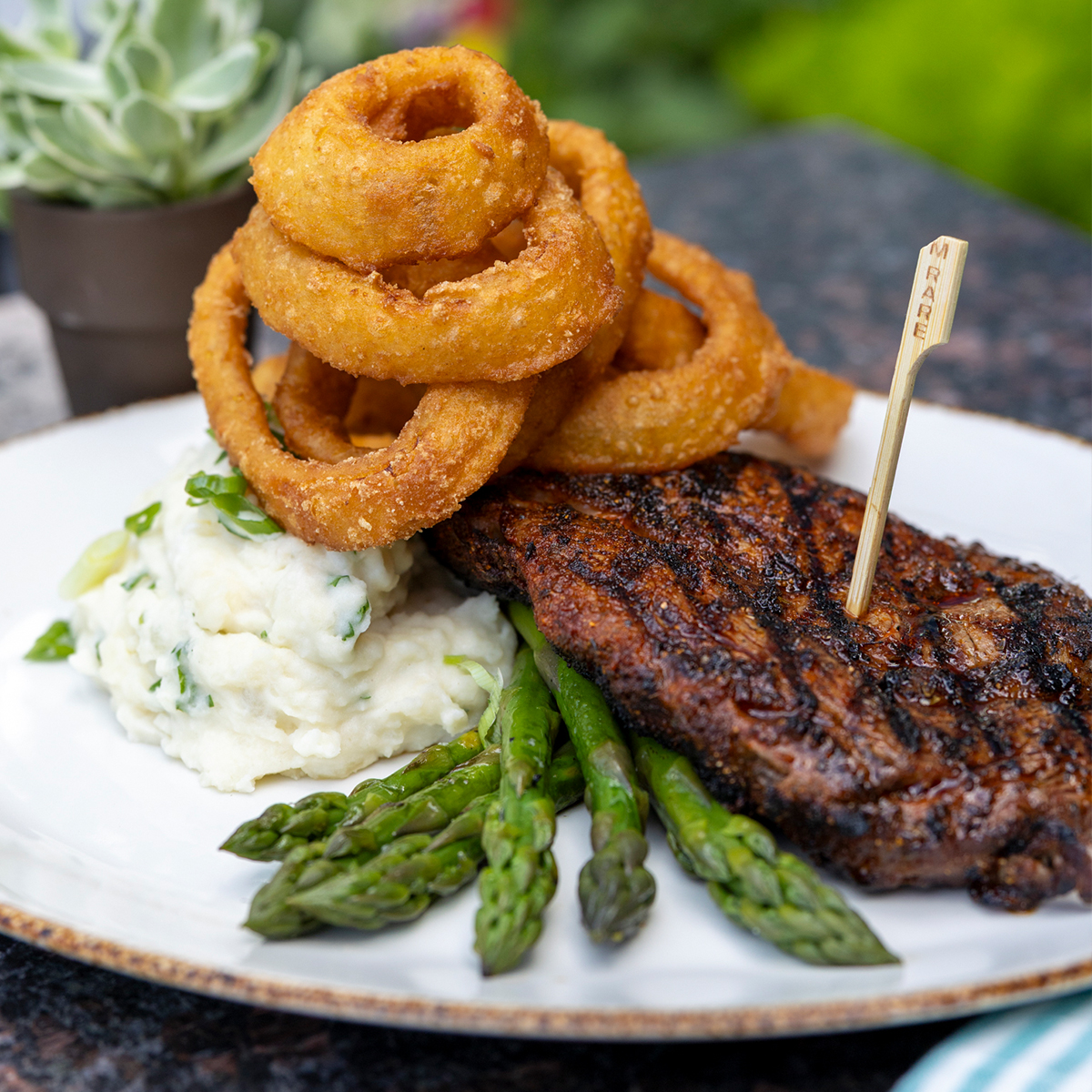 Cajun Ribeye | 14oz hand cut, onion rings, potato choice & grilled asparagus
