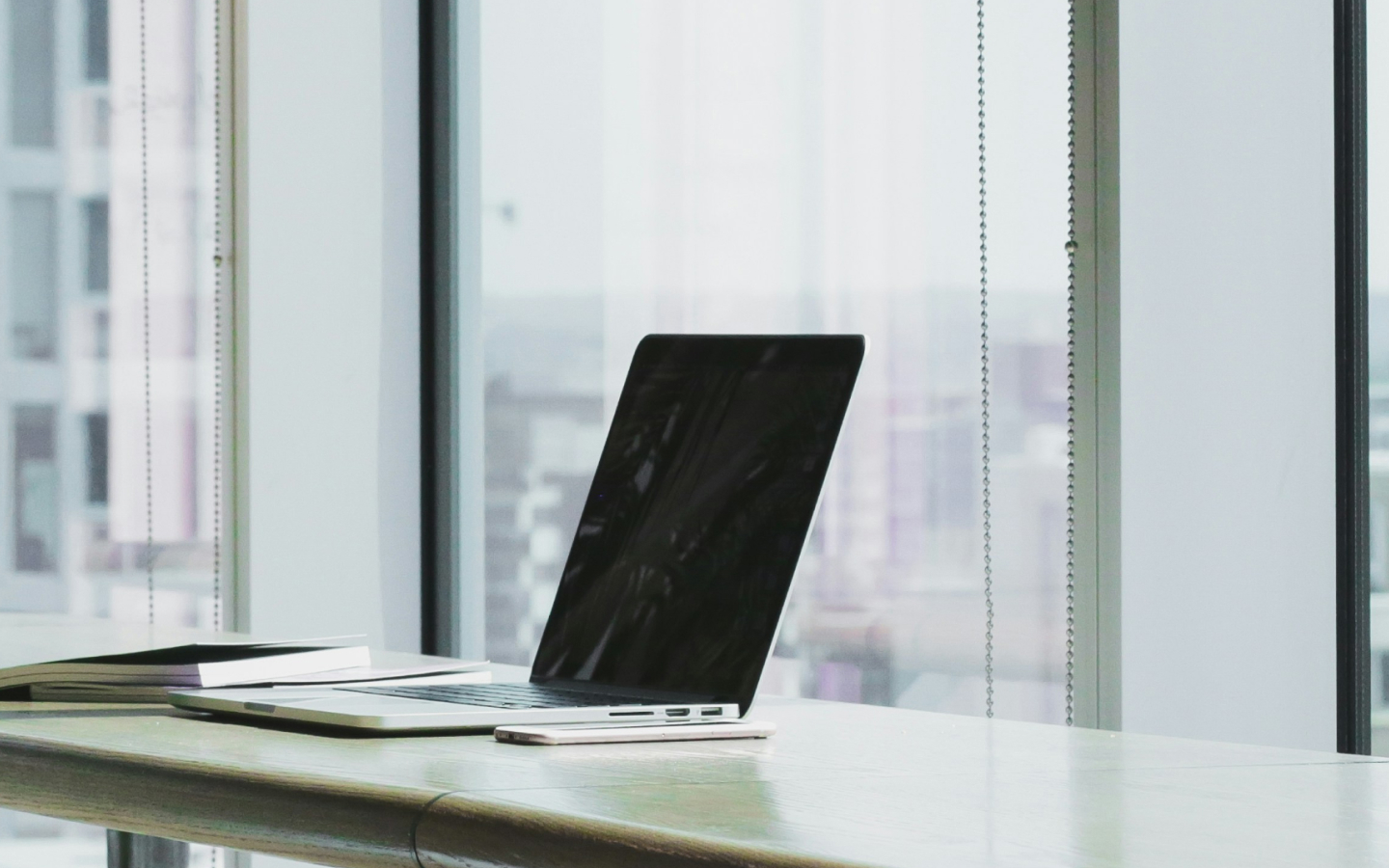 A desk with a laptop open.