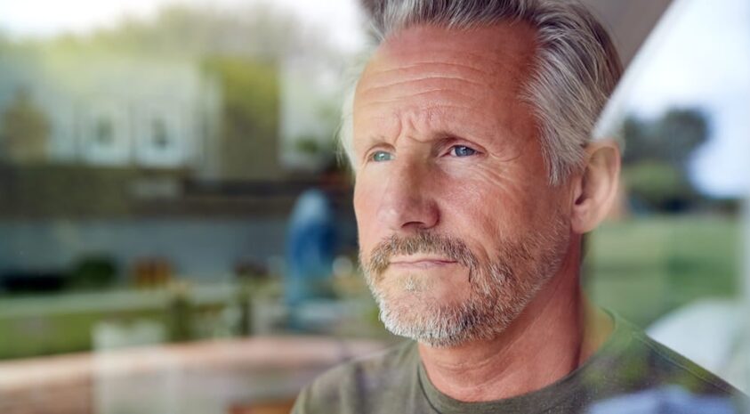 Aging man looks thoughtful as he ponders his financial circumstances.