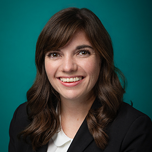 Female family medicine physician smiling in professional headshot.