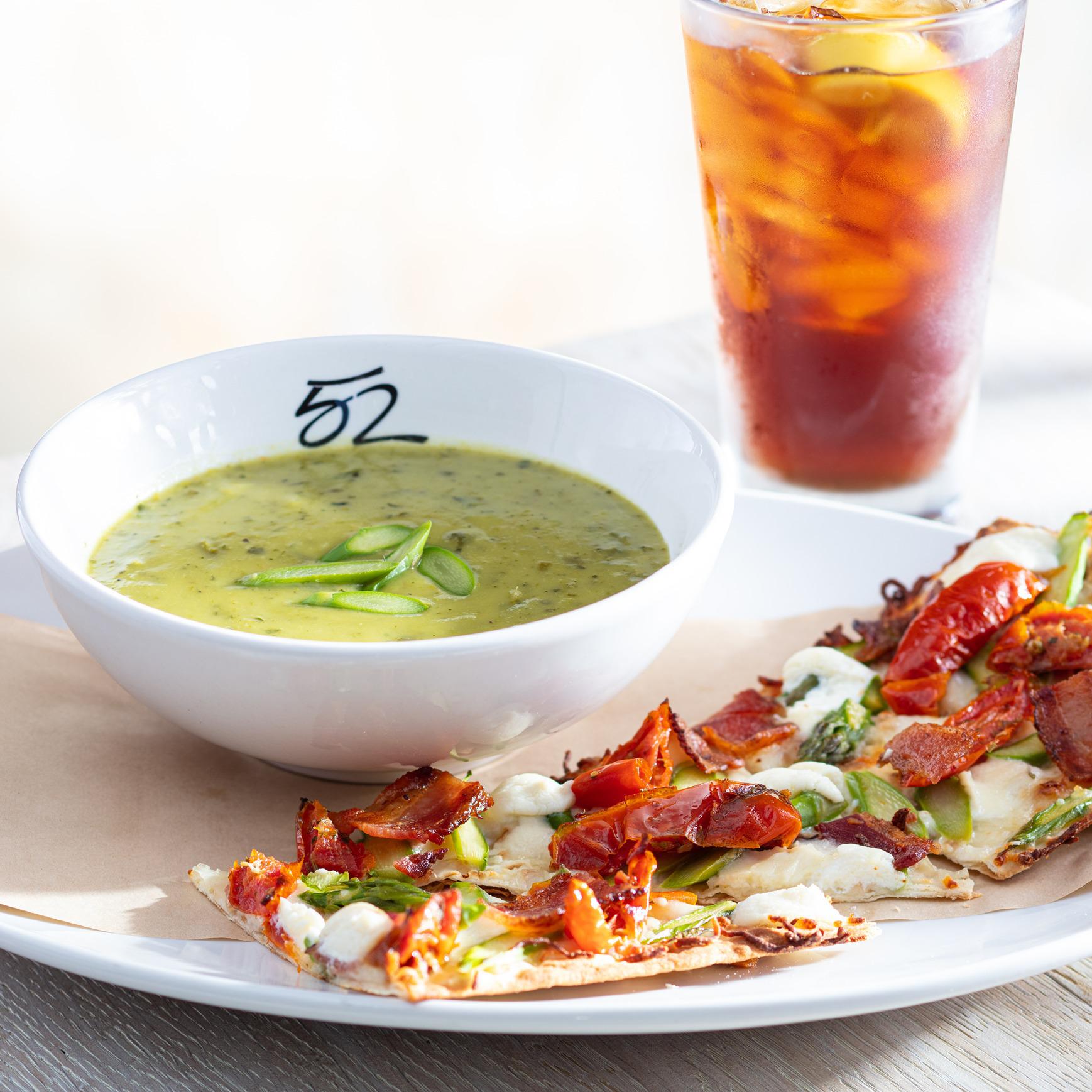 Our seasonal menu offers a variety of lunch pairings of a half flatbread with a soup or salad, as well as entrées and handhelds